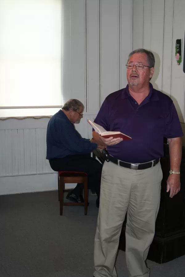 Mike Briley leads singing, accompanied by John Points