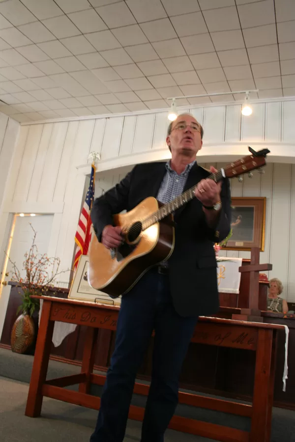 Rev. Vic Casad plays and sings to close the program