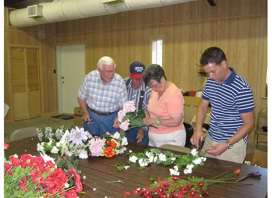 Darwin McGill, Louis & Jo Ann Agee & Ryan Agee preparing the flowers to adorn the cemetery