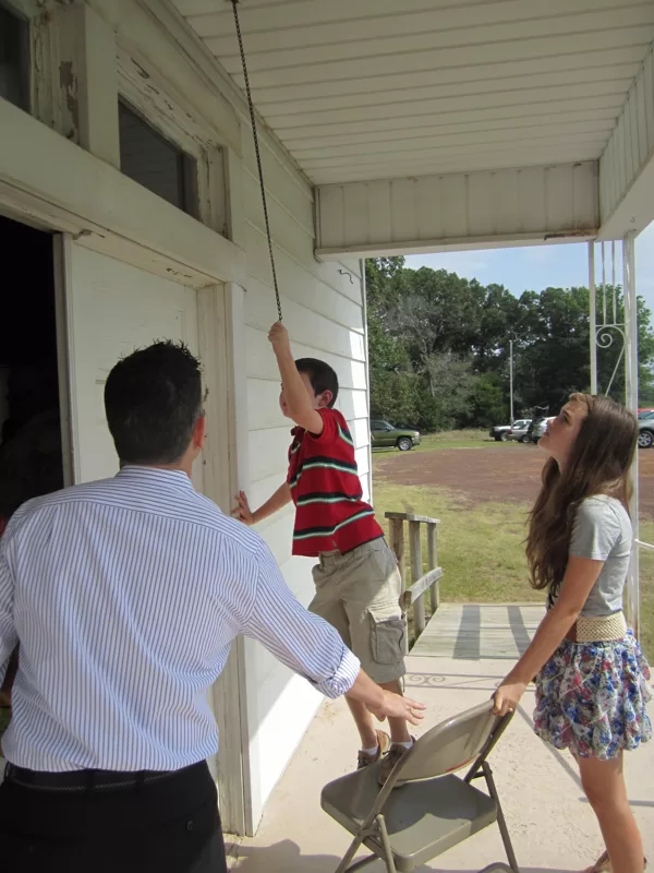 Ringing the bell to announce the start of the program